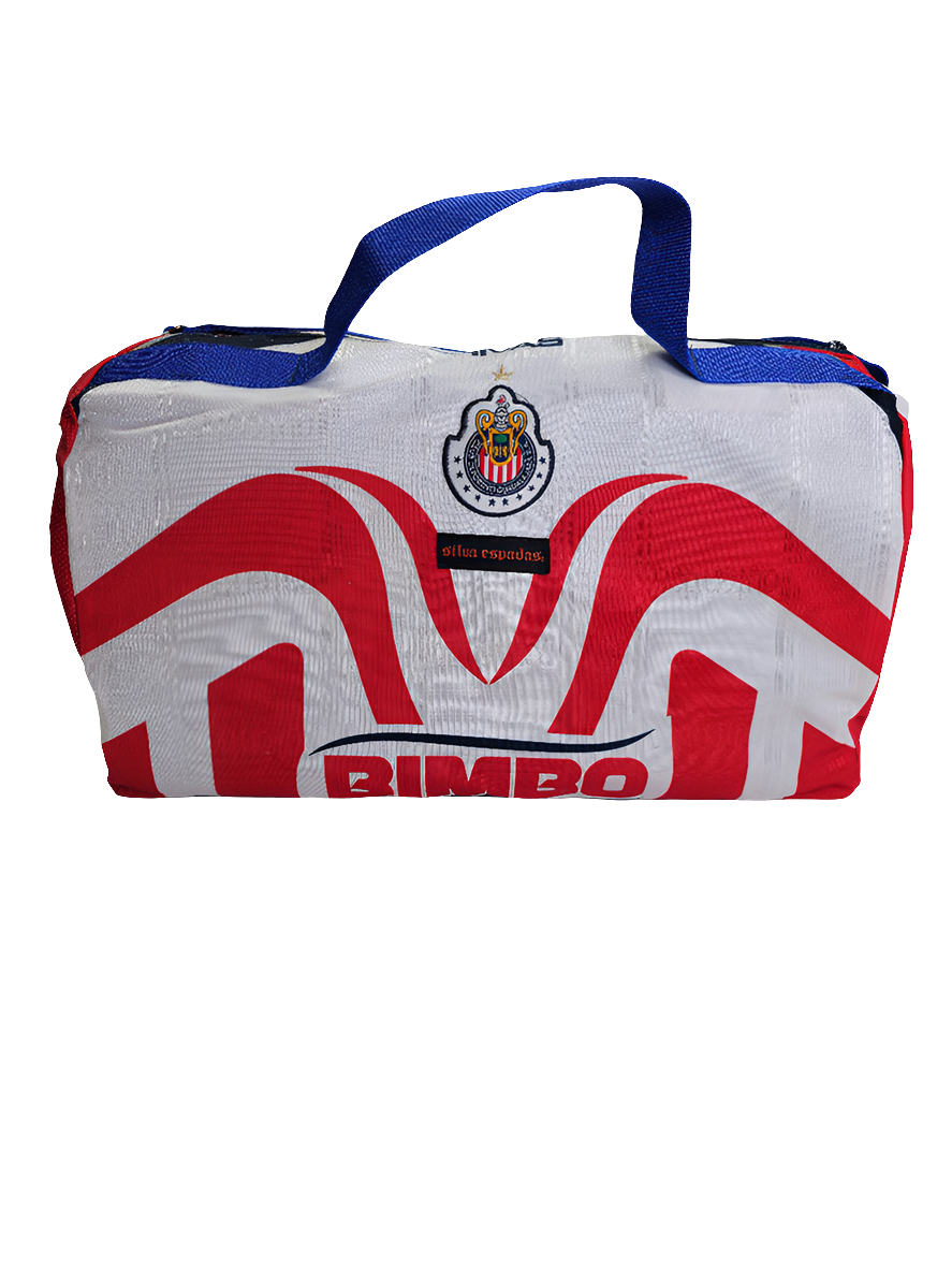 A custom handmade duffle bag made from a Chivas de Guadalajara jersey and heavy canvas, predominantly white with red accents and the Chivas and Bimbo bread logo.