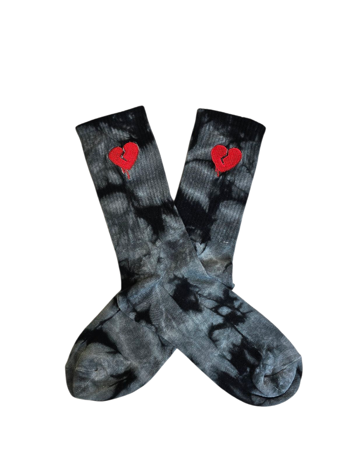 Black tie-dye socks with red broken heart embroidered designs on a white background