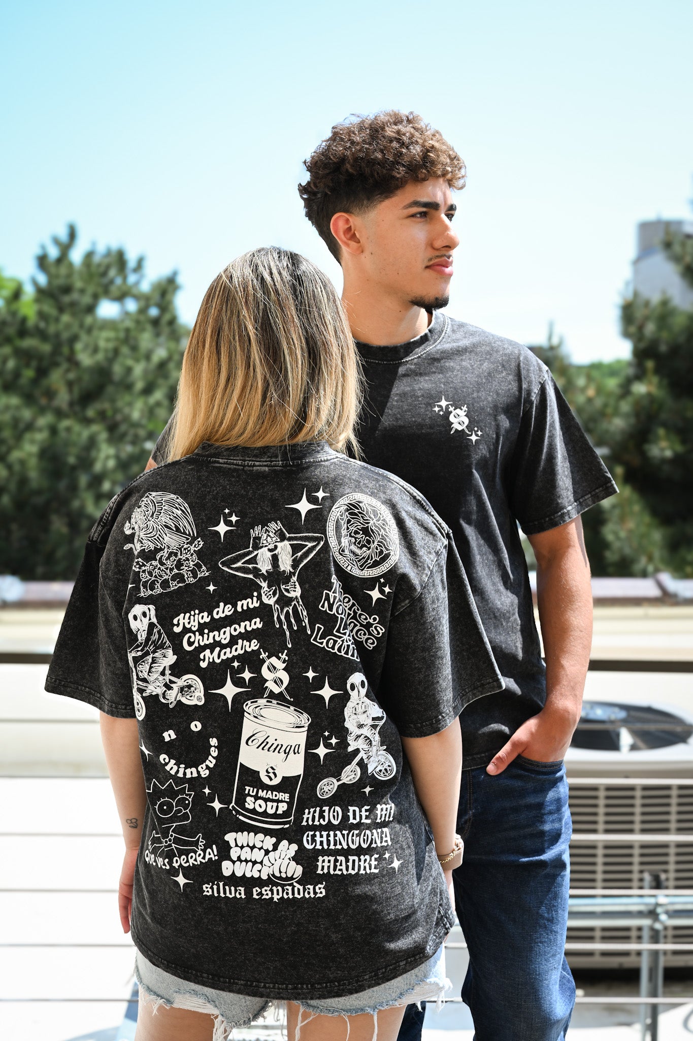 Latino models wearing Silva Espadas graphic streetwear tees on urban rooftop