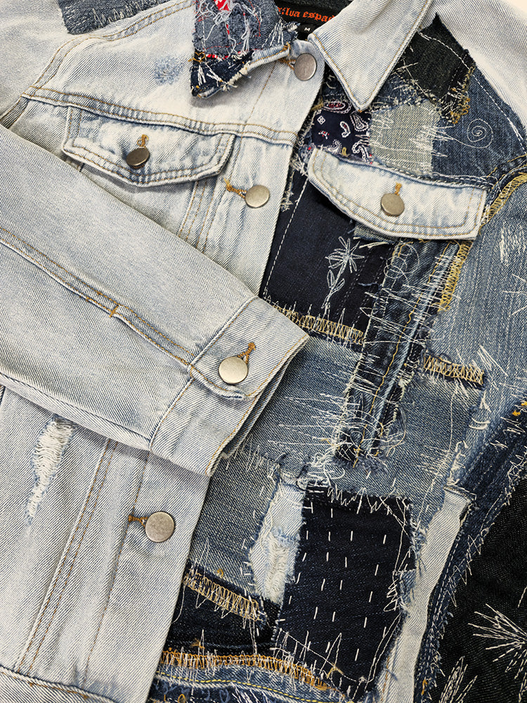 Close-up of repurposed denim jacket showing stitched patch panels in various textures and indigo wash tones