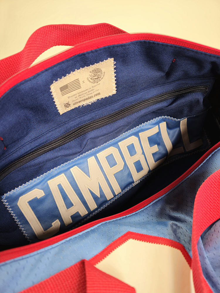 A custom handmade duffle bag made from a Houston Oilers Earl Campbell jersey in powder blue with red accents and the old school vintage Oilers logo