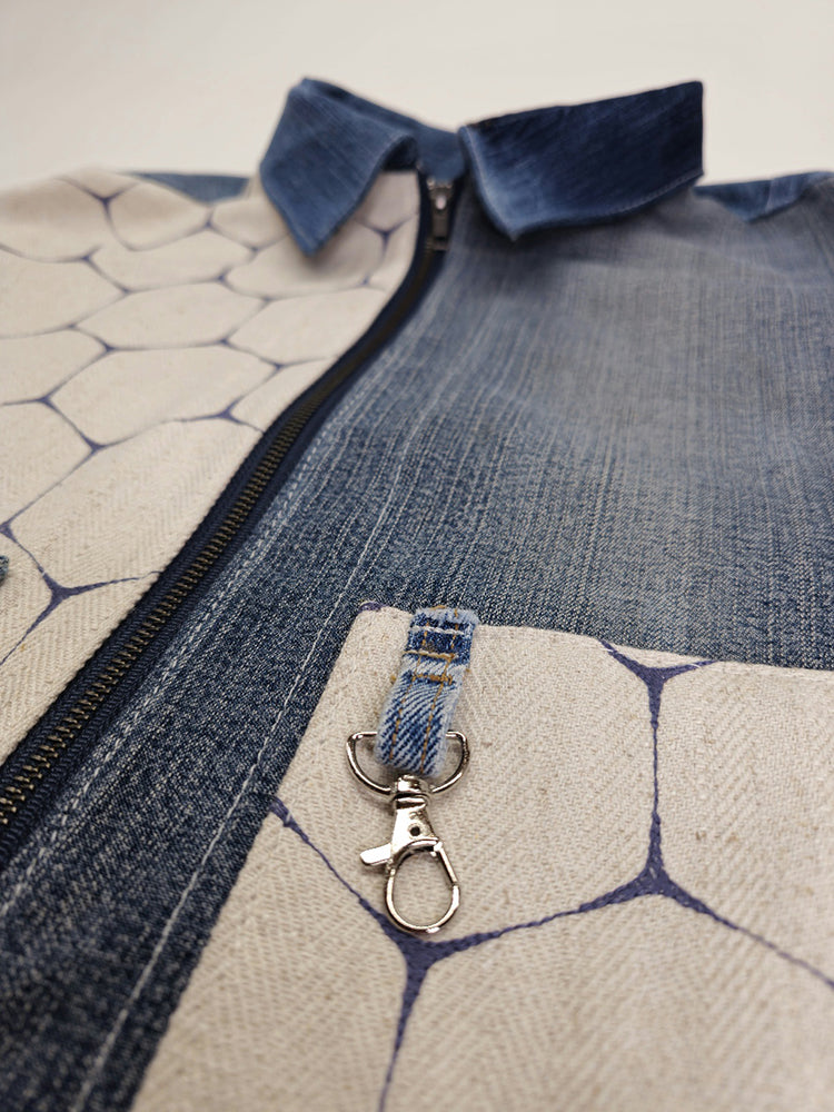 Key chain on a denim jean jacket pocket detail