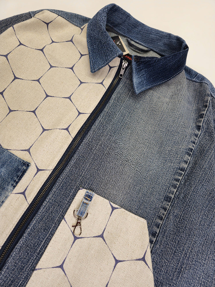 A denim honeycomb jacket with two slanted opening pockets on front panels and a boxy fit. The jacket features a mix of solid denim and honeycomb patterned fabrics.
