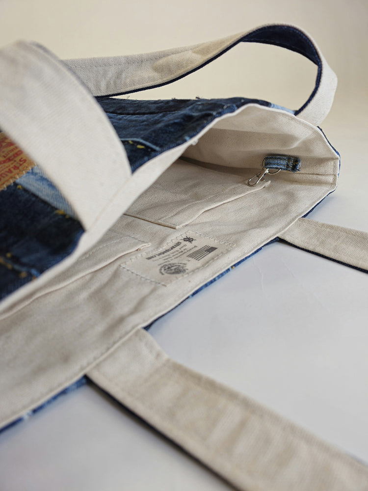 A close up view of the inside pockets of a handmade denim tote bag