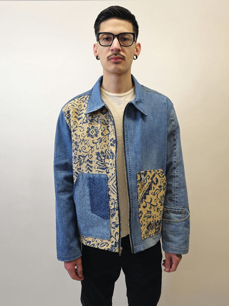Person wearing a denim floral jacket