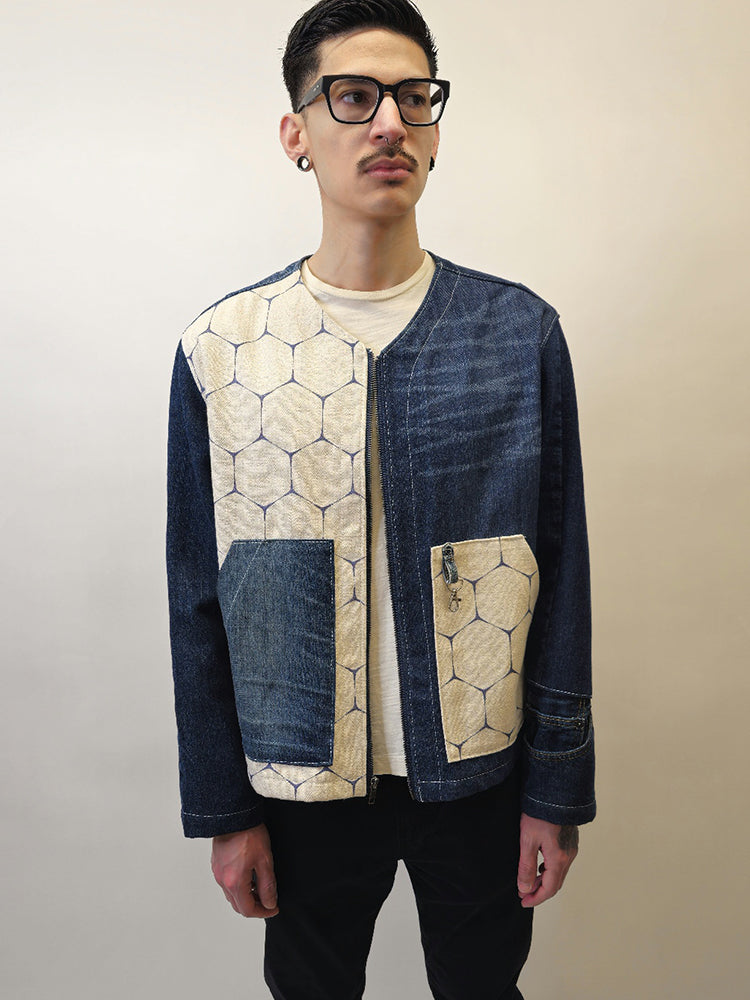 Person wearing a dark denim jean jacket