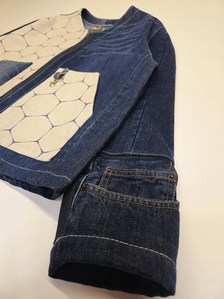 angled close up view of a denim jacket sleeve pocket
