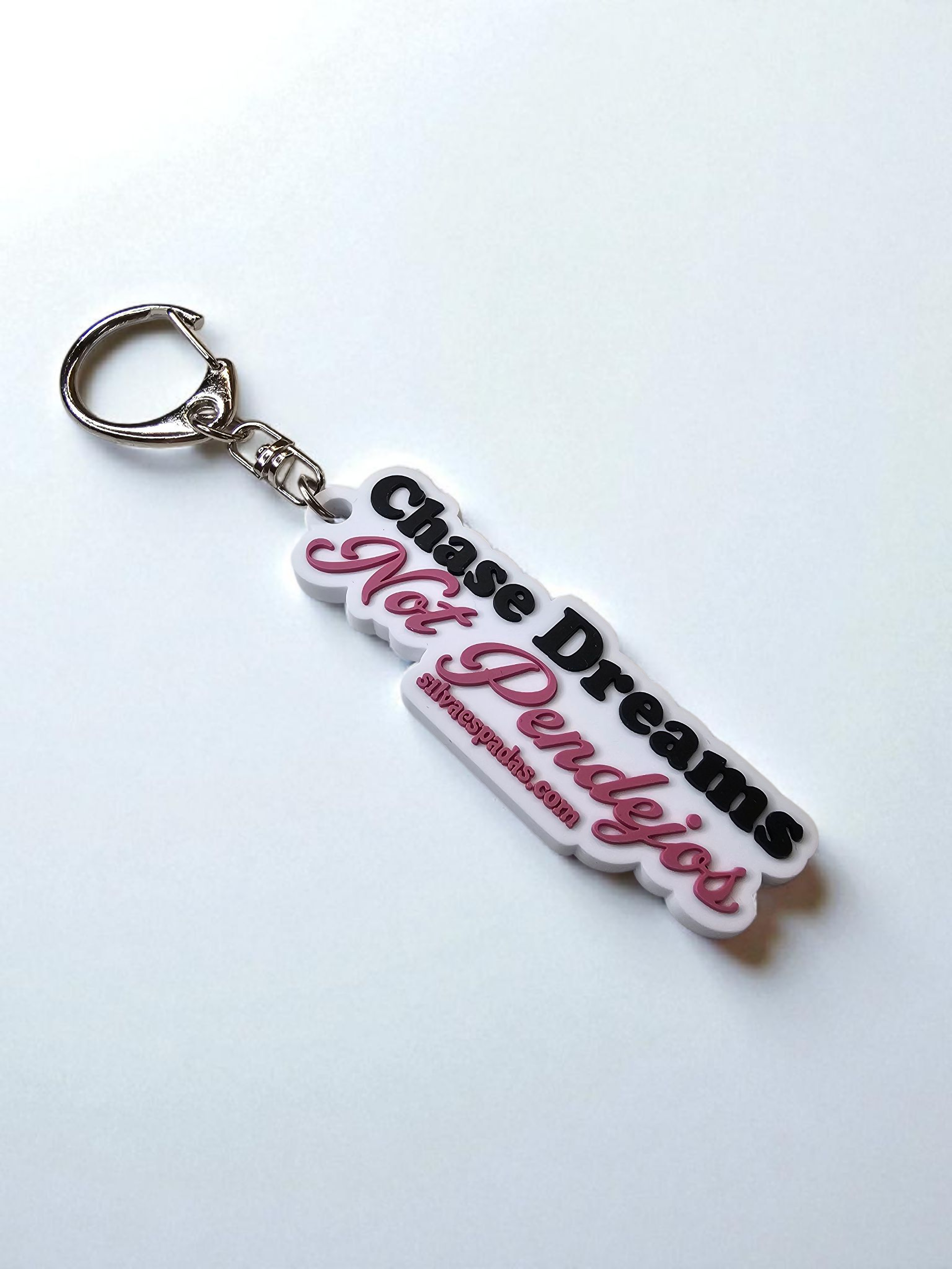 Keychain with 'Chase Dreams, Not Pendejos' text on a white background