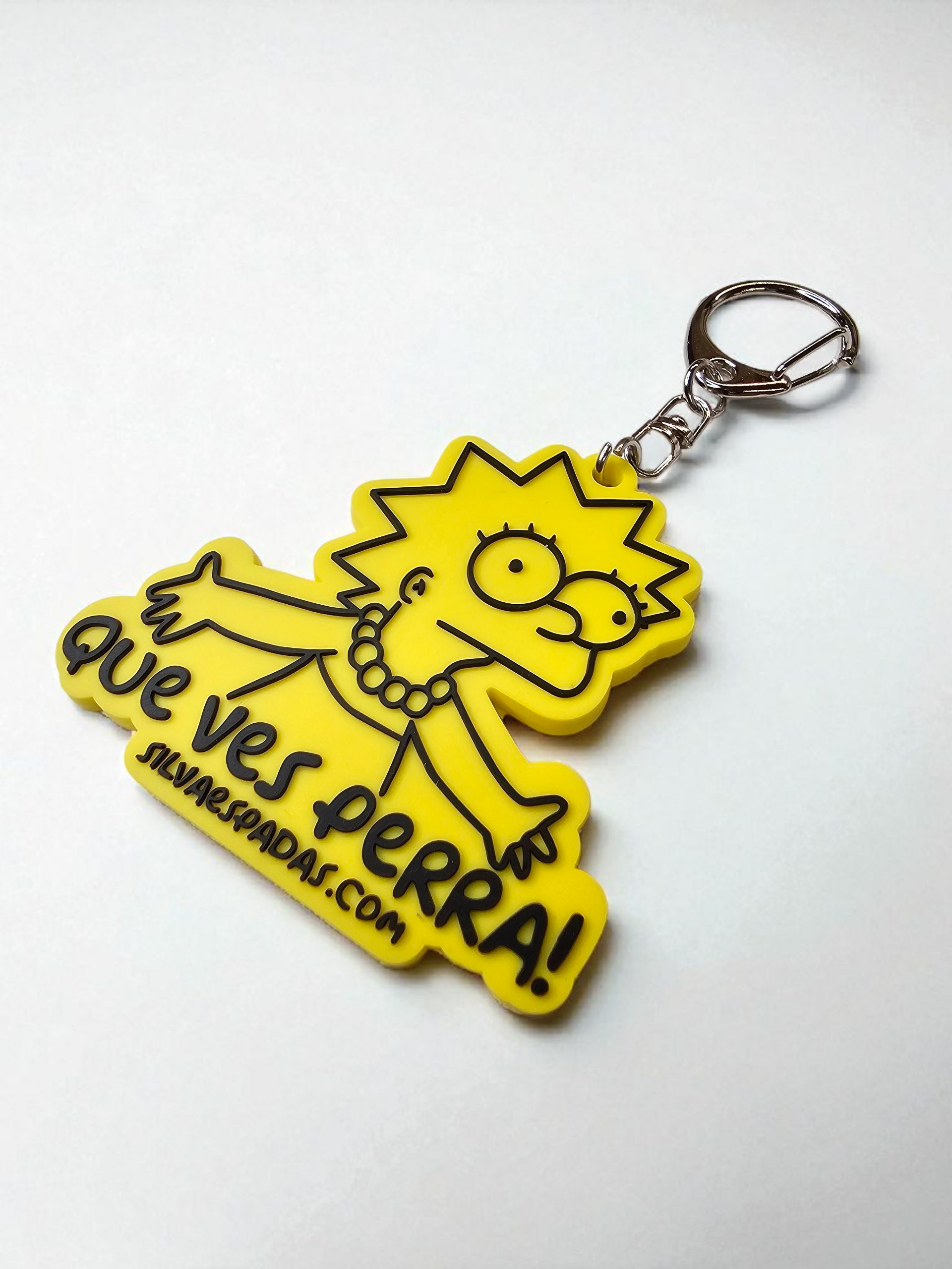 Yellow keychain with cartoon character and text on a white background