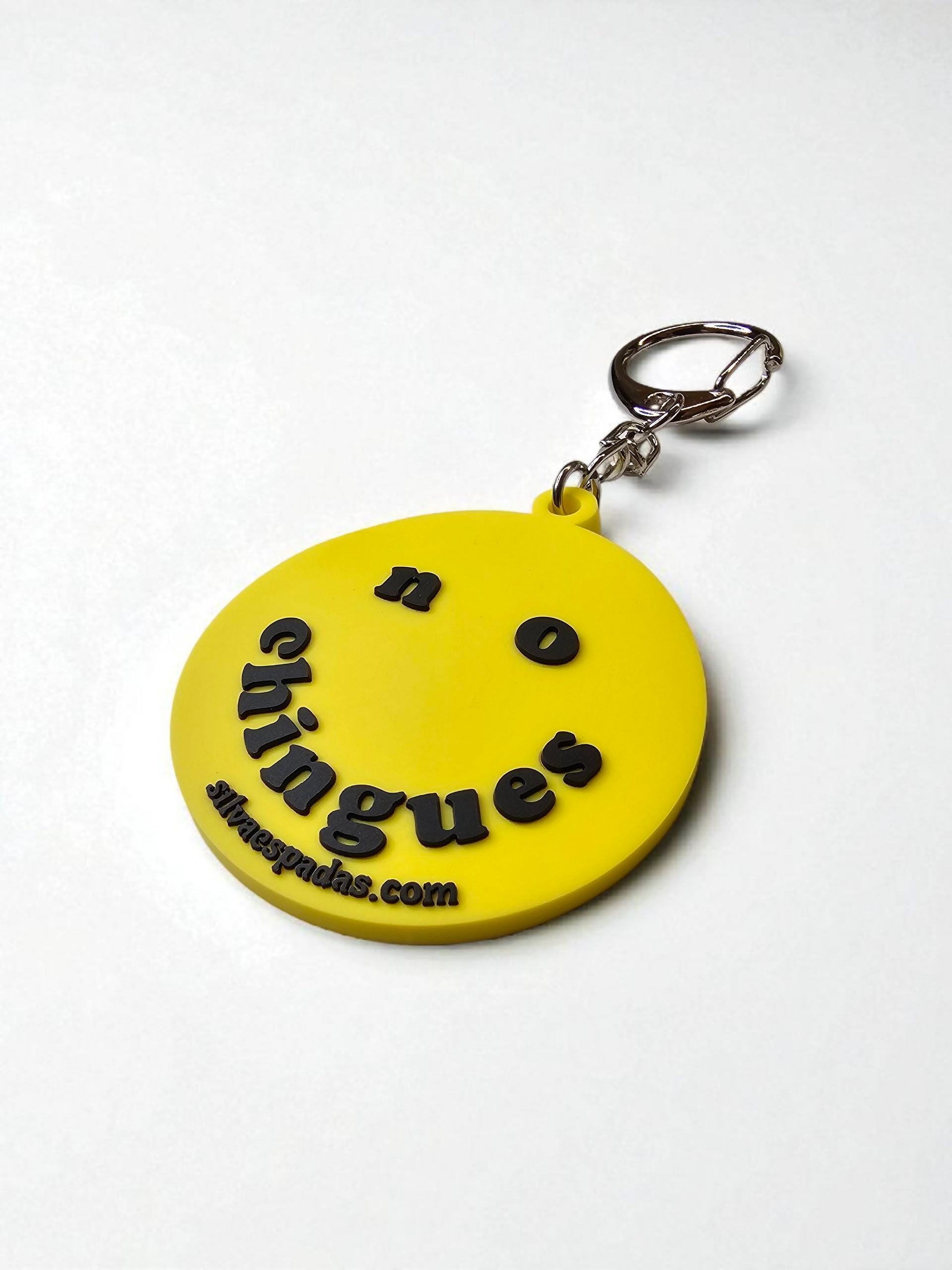 Yellow keychain with black text on a white background