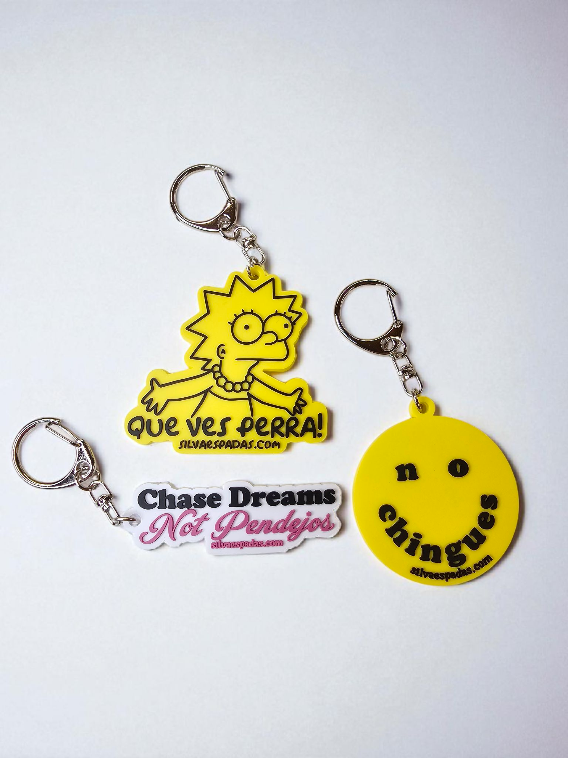 Three keychains with different designs on a white background