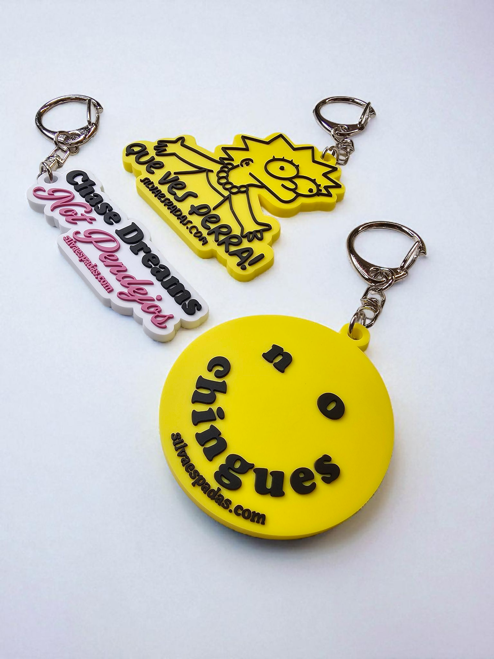 Three keychains with different designs on a white background