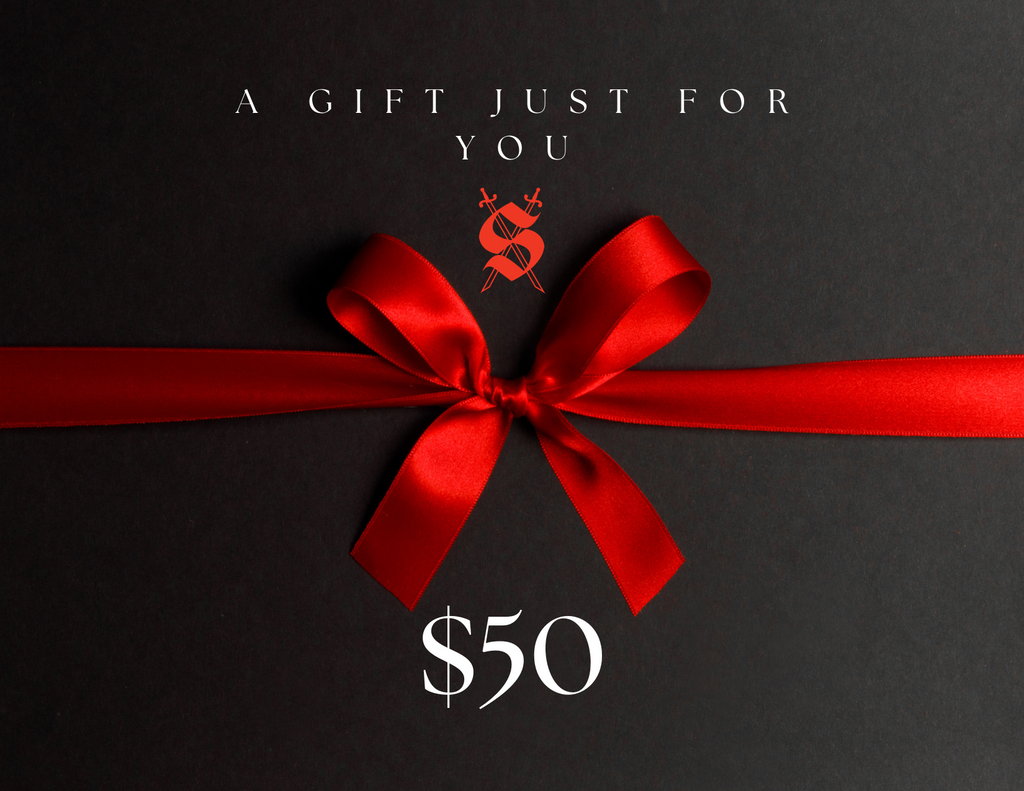 A red ribbon gift card with a silver embossed logo and text that reads 'A Gift Just For You' from Silva Espadas, denomination $50