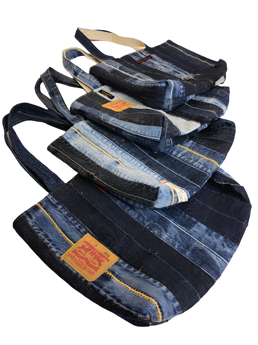 Four blue denim patchwork tote bags with straps, featuring distressed details and a brand tag on the lower side.