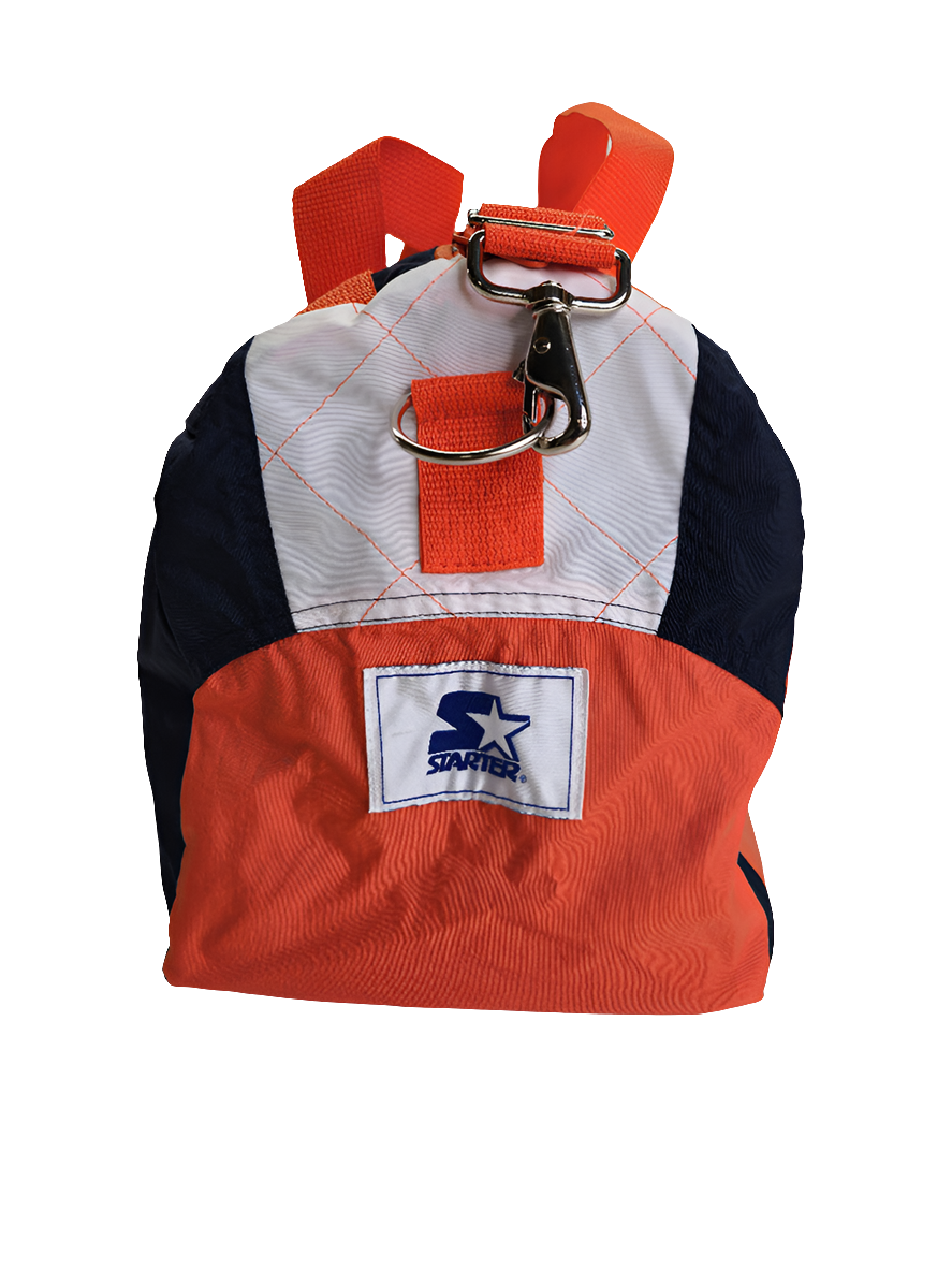 A custom handmade duffle bag made from a Chicago Bears Starter jacket and heavy canvas, predominantly navy blue with orange accents and the Bears and Starter brand