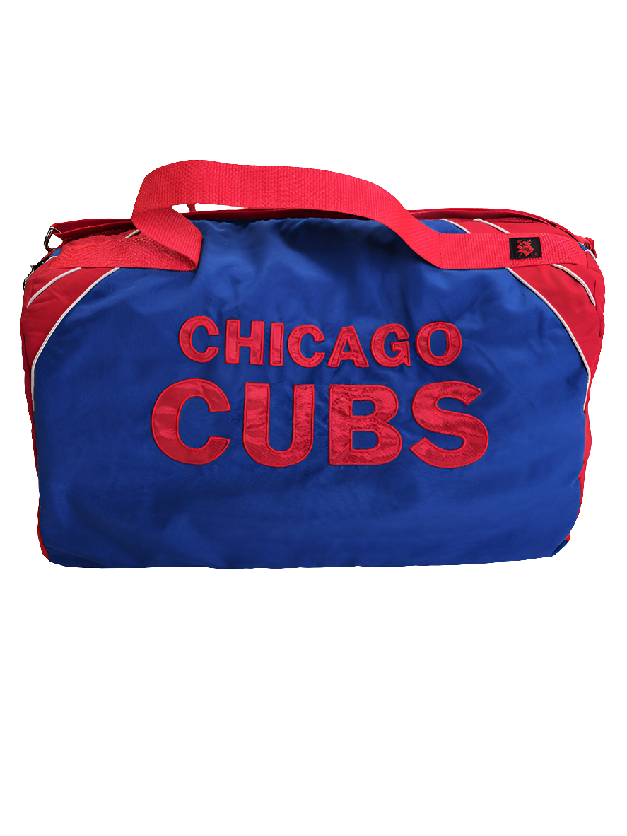 A custom handmade duffle bag made from a Chiago Cubs Genuine Merchendise jacket and heavy canvas, predominantly blue with red and white accents and the words "Chicago Cubs".