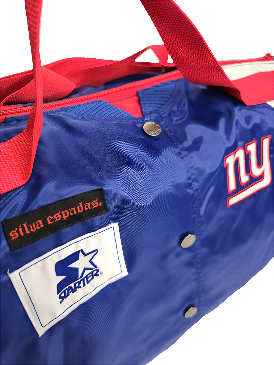 A custom handmade duffle bag made from a NY Giants Starter jacket and heavy canvas, predominantly blue with red and white accents and the NY Giants logo.