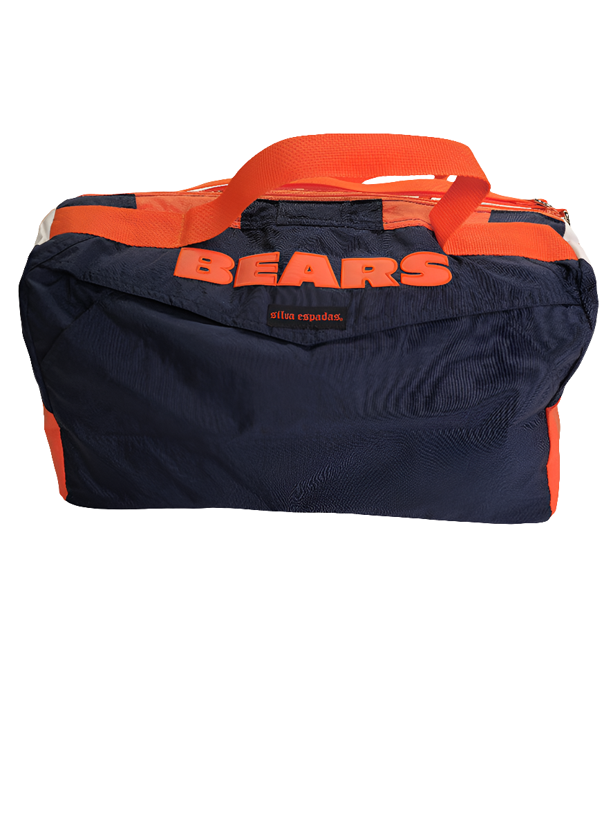 A custom handmade duffle bag made from a Chicago Bears Starter jacket and heavy canvas, predominantly navy blue with orange accents and the Bears logo