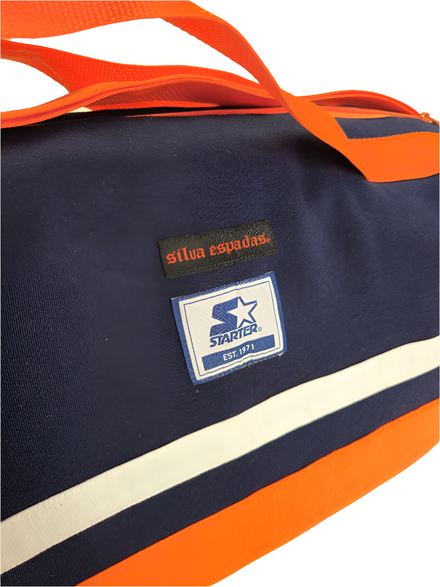 A custom handmade duffle bag made from a Chiago Bears Starter jacket and heavy canvas, predominantly navy blue with orange accents and the Bears logo