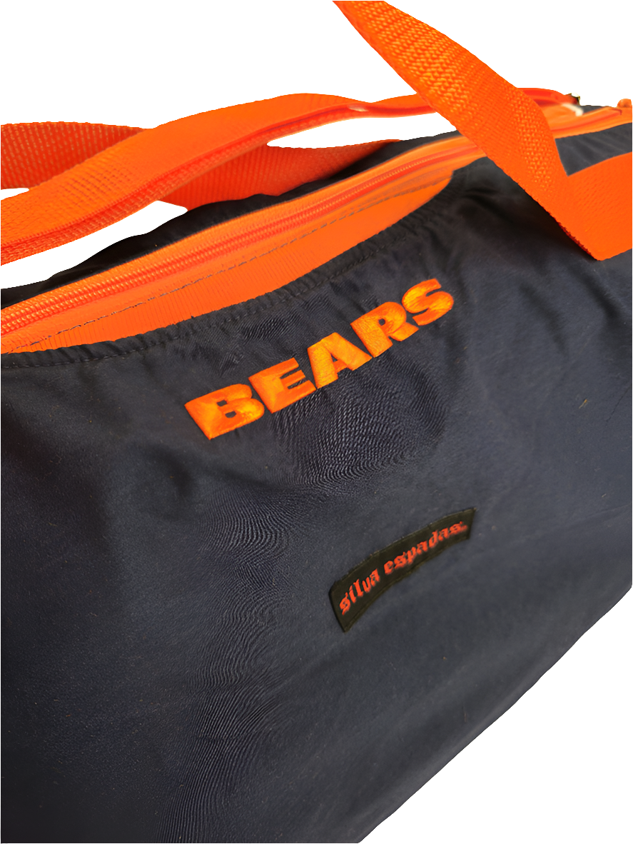 A custom handmade duffle bag made from a Chicago Bears jacket and heavy canvas, predominantly blue with orange accents and the Bears C logo.
