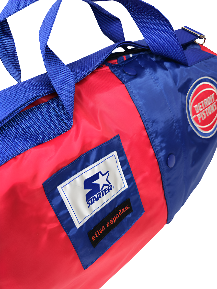 A custom handmade duffle bag made from a Detroit Pistons Starter jacket with the Pistons and Starter brand logo