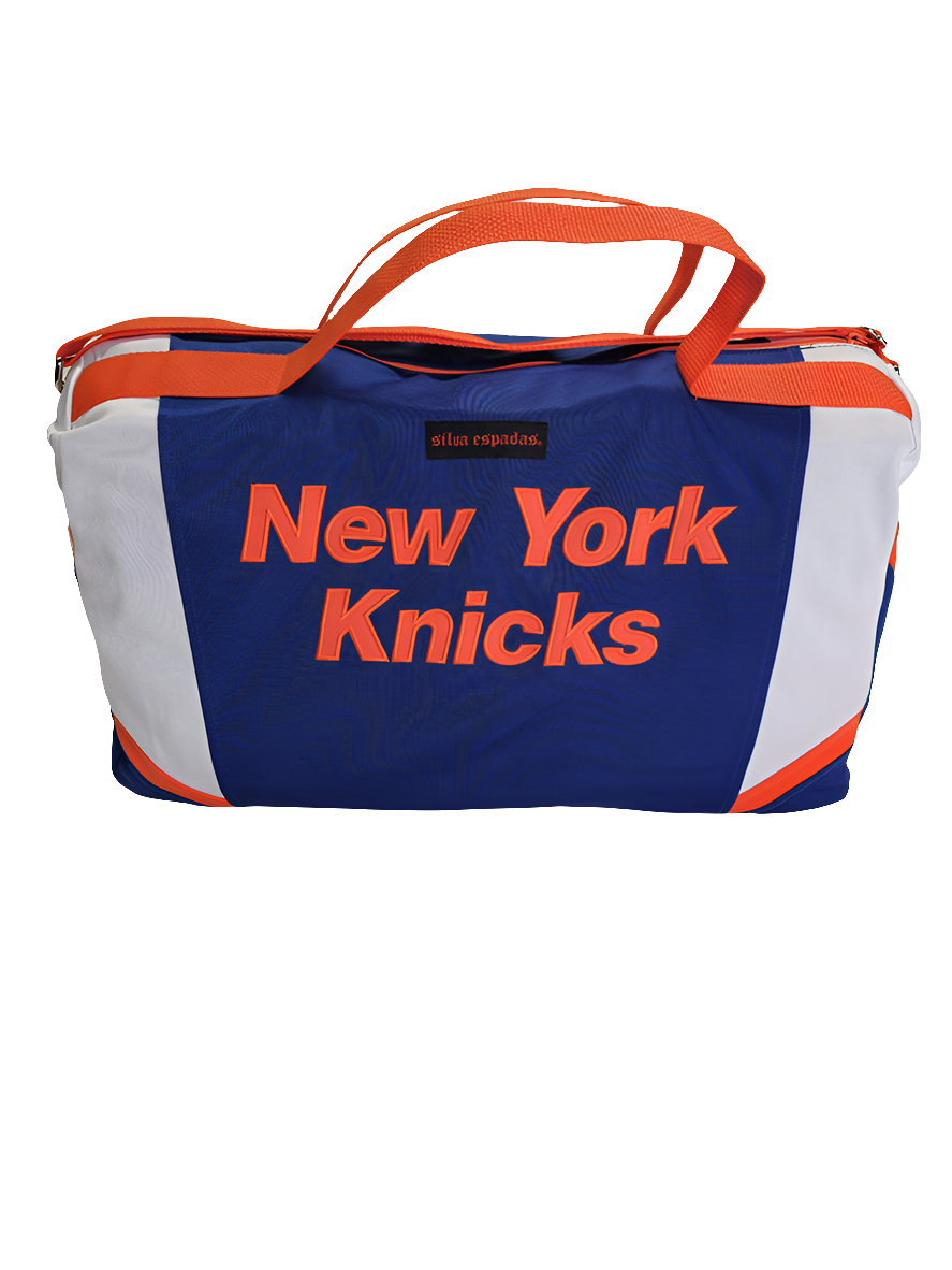 A blue and orange custom handmade duffle bag with the text 'NEW YORK KNICKS' printed on the side, featuring a logo and a chain strap.