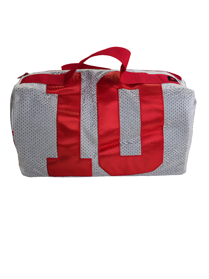 A custom handmade duffle bag made from a NY Giants Manning jersey and heavy canvas, predominantly white with red and accents and the number 10