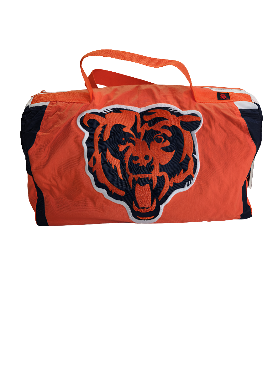A custom handmade duffle bag made from a Chicago Bears Starter jacket and heavy canvas, predominantly navy blue with orange accents and the Bears logo