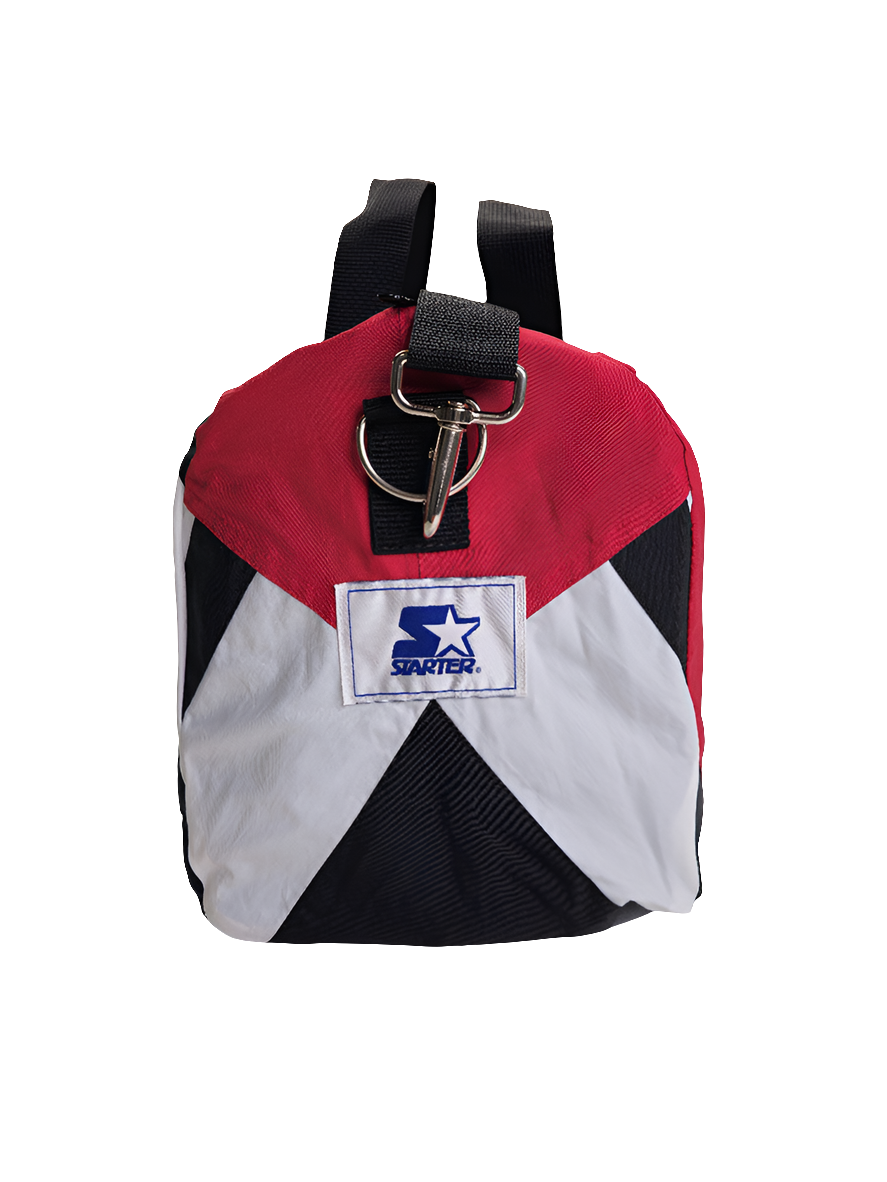 Side view of a red and black handmade duffle bag with the Atlanta Falcons logo and starter jacket hoodie design.
