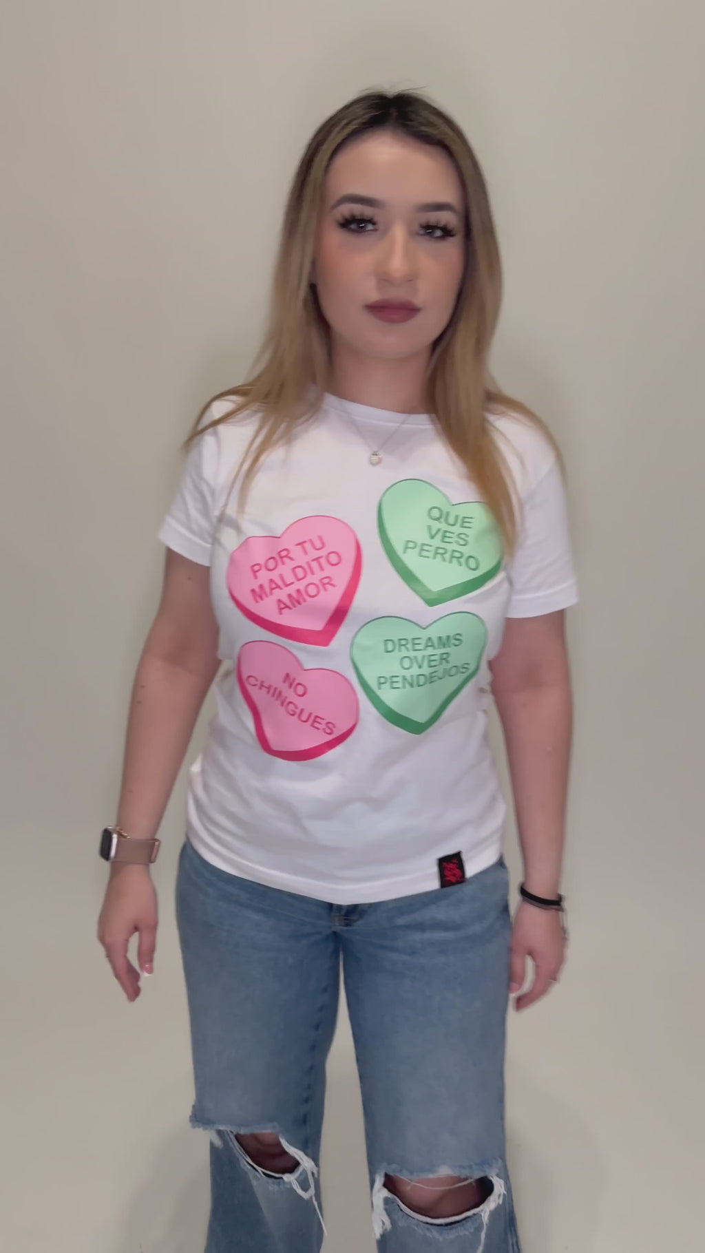 Latina modeling a white t-shirt with candy hearts graphic design