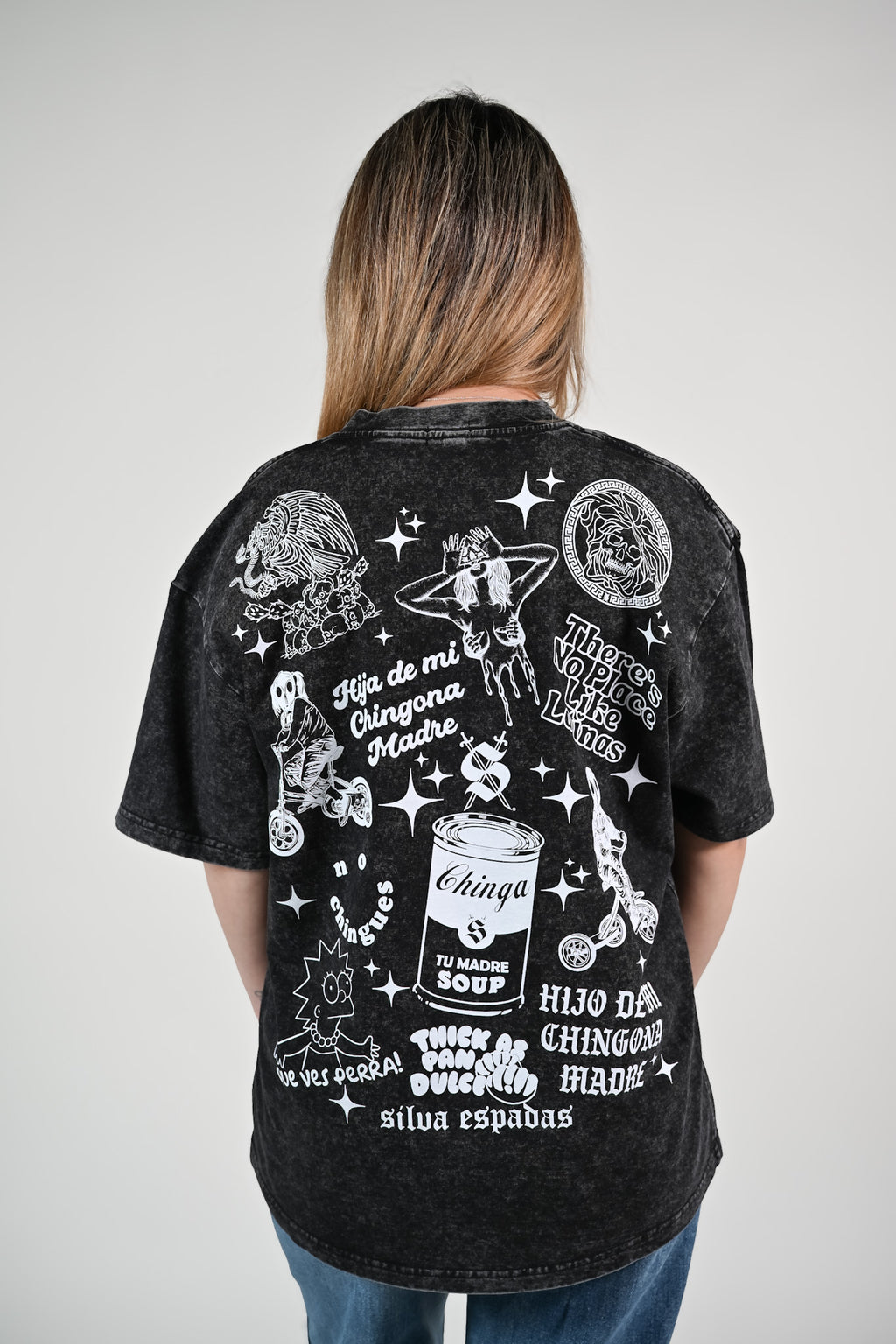 Latina modeling a black overized tee with latino inspired graphics