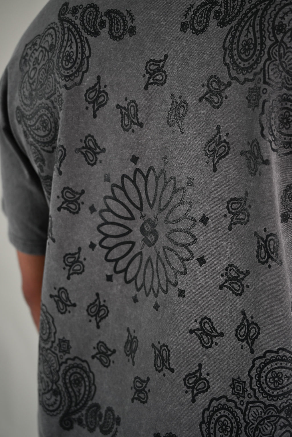 Gray t-shirt with black paisley bandana pattern on a plain background by Silva Espadas