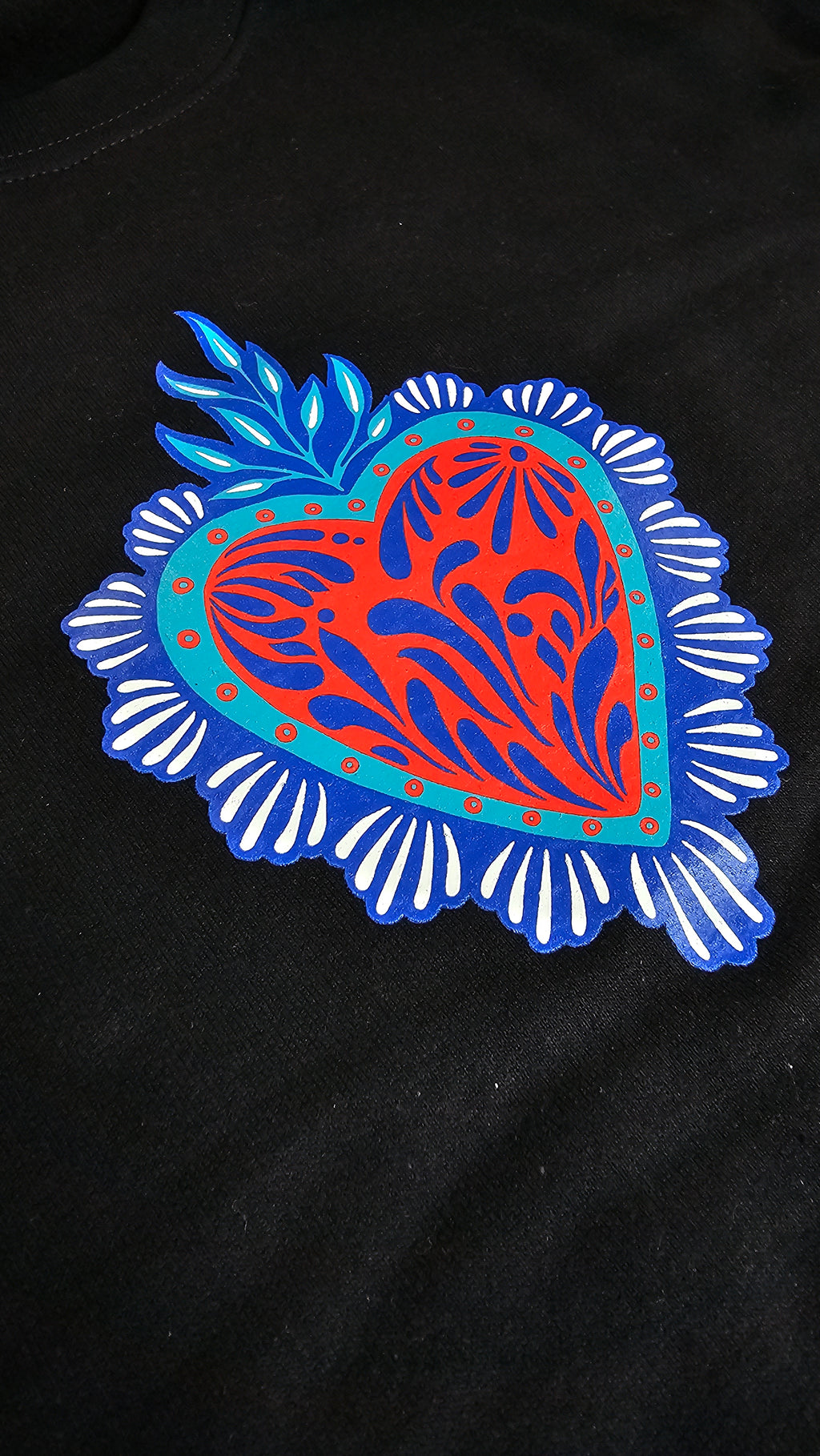 detail view of a colorful talavera heart design