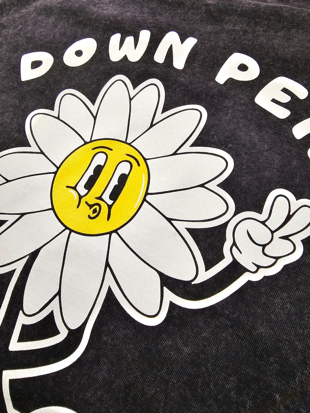 Black t-shirt with a white flower graphic and 'Down Pe' text on a black background