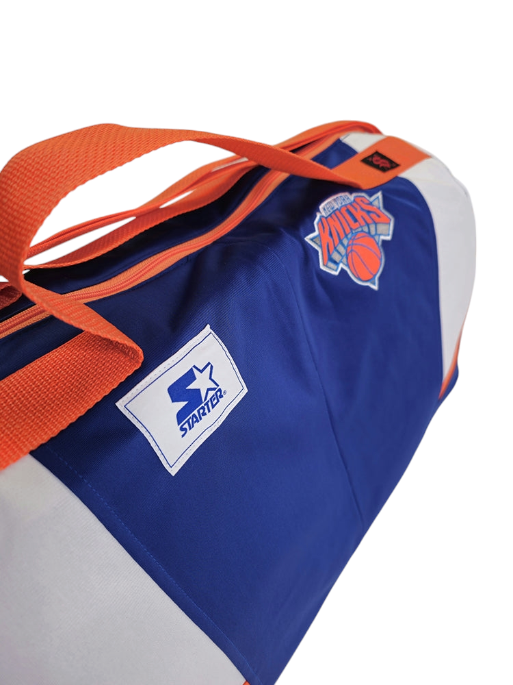 A handmade custom duffle bag made from NY Knicks Starter jacket