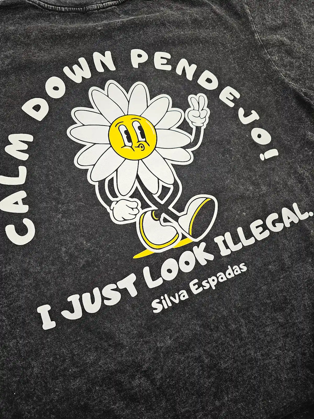 Black t-shirt with a cartoon flower and text on a dark background